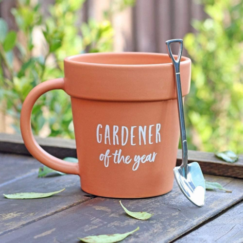 mug shaped like a ceramic pot that reads "gardener of the year" with a mini silver shovel spoon